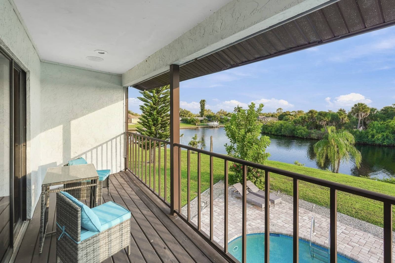 Upstairs balcony with seating above the pool and canal