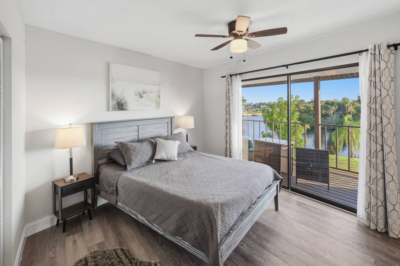 Primary bedroom with queen bed and sliding door to the balcony